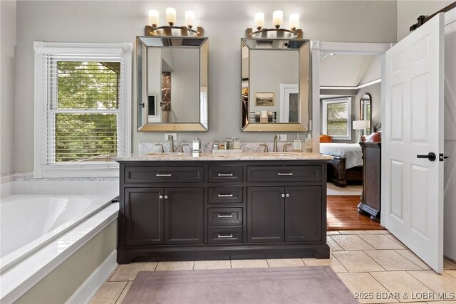 7 Lost Spike Ct, Camdenton, MO 65020 - ensuite bathroom featuring healthy amount of natural light, double vanity, and tile patterned floors