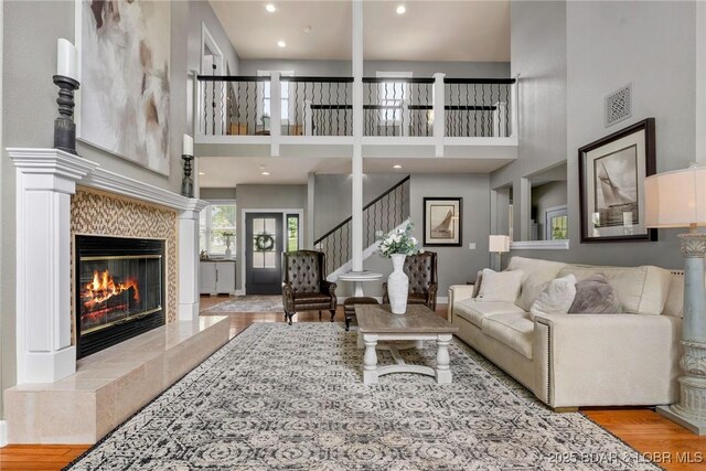 7 Lost Spike Ct, Camdenton, MO 65020 - living area with a high ceiling, a fireplace, wood finished floors, and stairway