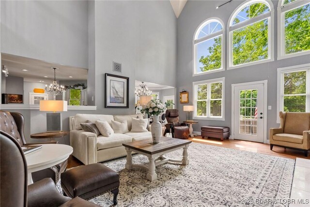 7 Lost Spike Ct, Camdenton, MO 65020 - living area with a chandelier, a high ceiling, plenty of natural light, and wood finished floors