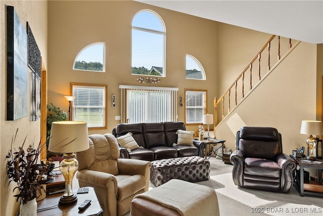 2326 Willow Creek Rd, Camdenton, MO 65020 - carpeted living room featuring stairway and a towering ceiling