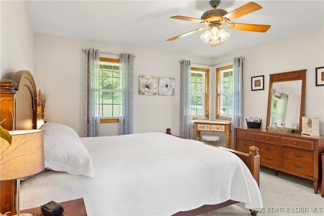 2326 Willow Creek Rd, Camdenton, MO 65020 - bedroom with multiple windows, ceiling fan, and light carpet