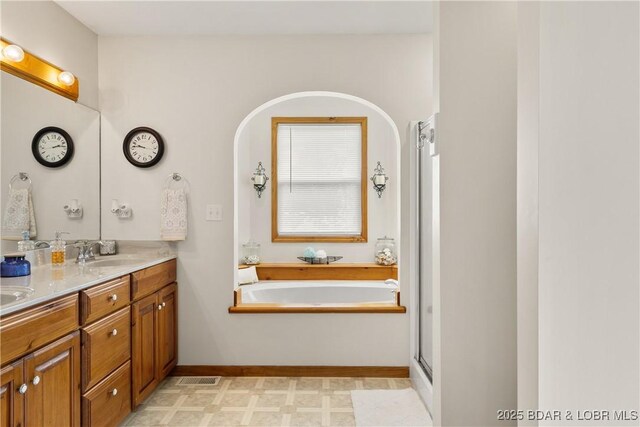 2326 Willow Creek Rd, Camdenton, MO 65020 - full bathroom with a bath, double vanity, an enclosed shower, and tile patterned floors