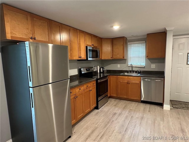 20 Barba Le Ln, Lake Ozark, MO 65049 - kitchen featuring appliances with stainless steel finishes, light wood-style flooring, and brown cabinets