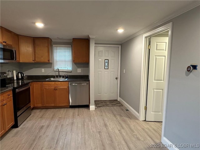 20 Barba Le Ln, Lake Ozark, MO 65049 - kitchen with appliances with stainless steel finishes, ornamental molding, light wood-style floors, dark countertops, and brown cabinets