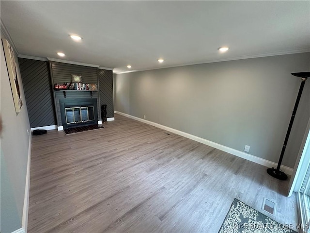 20 Barba Le Ln, Lake Ozark, MO 65049 - unfurnished living room featuring ornamental molding, a fireplace, recessed lighting, and wood finished floors