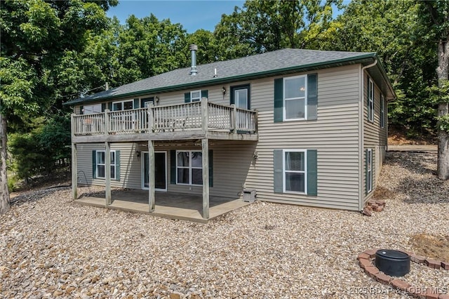 1508 Purvis Rd, Sunrise Beach, MO 65079 - back of property with a patio, a deck, and view of wooded area