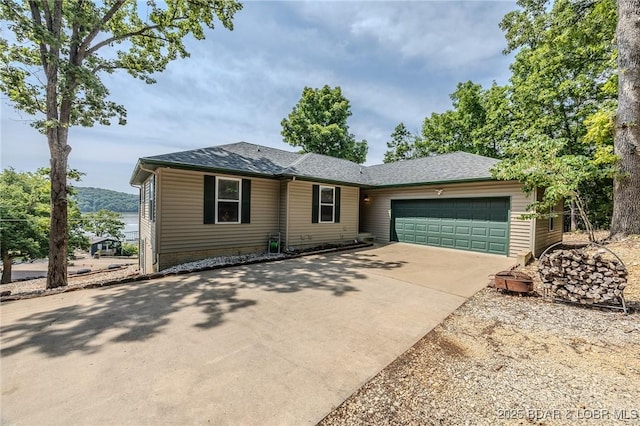 1508 Purvis Rd, Sunrise Beach, MO 65079 - view of front of home featuring a garage, driveway, and a shingled roof