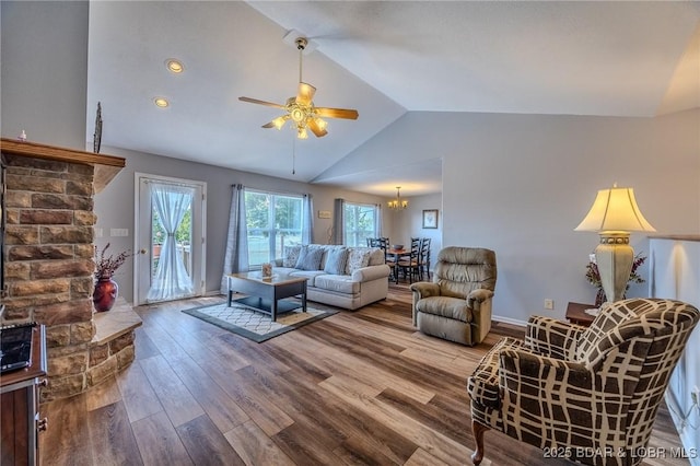 1508 Purvis Rd, Sunrise Beach, MO 65079 - living room featuring lofted ceiling, ceiling fan, wood finished floors, and a chandelier