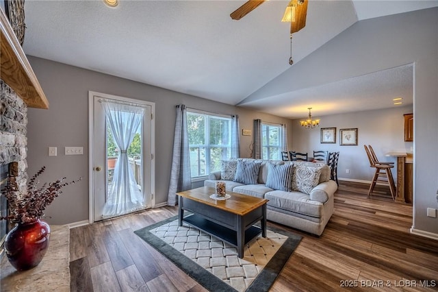 1508 Purvis Rd, Sunrise Beach, MO 65079 - living area with vaulted ceiling, wood finished floors, a chandelier, and a ceiling fan