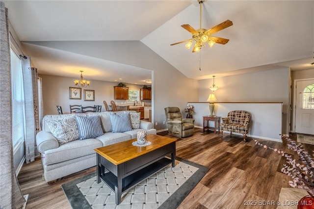 1508 Purvis Rd, Sunrise Beach, MO 65079 - living area featuring lofted ceiling, wood finished floors, a chandelier, and ceiling fan
