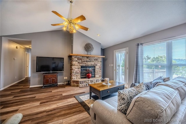 1508 Purvis Rd, Sunrise Beach, MO 65079 - living room featuring wood finished floors, ceiling fan, vaulted ceiling, and a fireplace