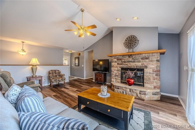 1508 Purvis Rd, Sunrise Beach, MO 65079 - living room with ceiling fan, wood finished floors, lofted ceiling, and a glass covered fireplace