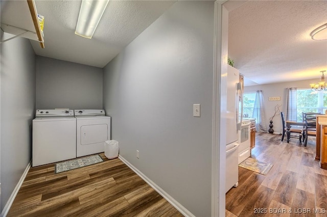 1508 Purvis Rd, Sunrise Beach, MO 65079 - washroom featuring washer and dryer, wood finished floors, a textured ceiling, and a chandelier