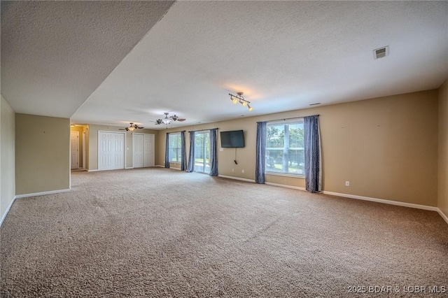 1508 Purvis Rd, Sunrise Beach, MO 65079 - carpeted spare room featuring a textured ceiling and track lighting