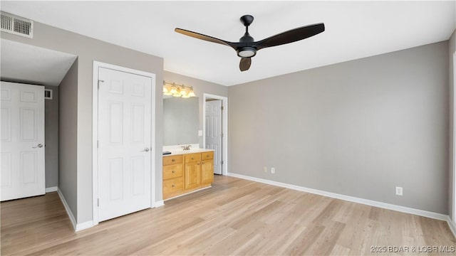 150 Southwood Shores Dr Unit 71-1B, Lake Ozark, MO 65049 - unfurnished bedroom with light wood-type flooring, ensuite bath, and ceiling fan
