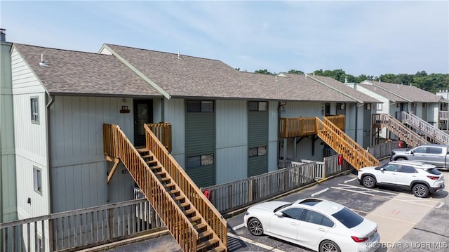 150 Southwood Shores Dr Unit 71-1B, Lake Ozark, MO 65049 - view of building exterior featuring stairs and uncovered parking