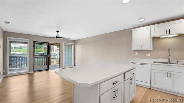 150 Southwood Shores Dr Unit 71-1B, Lake Ozark, MO 65049 - kitchen with white dishwasher, ceiling fan, light wood-style floors, light countertops, and open floor plan