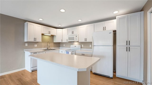 150 Southwood Shores Dr Unit 71-1B, Lake Ozark, MO 65049 - kitchen with white appliances, light countertops, light wood-type flooring, white cabinets, and recessed lighting