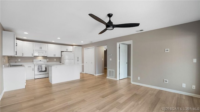 150 Southwood Shores Dr Unit 71-1B, Lake Ozark, MO 65049 - kitchen featuring white appliances, a ceiling fan, a center island, light countertops, and light wood finished floors