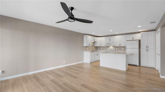 150 Southwood Shores Dr Unit 71-1B, Lake Ozark, MO 65049 - kitchen with white appliances, ceiling fan, light countertops, white cabinetry, and light wood-style flooring