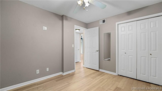 150 Southwood Shores Dr Unit 71-1B, Lake Ozark, MO 65049 - unfurnished bedroom featuring light wood-style floors, a closet, and a ceiling fan