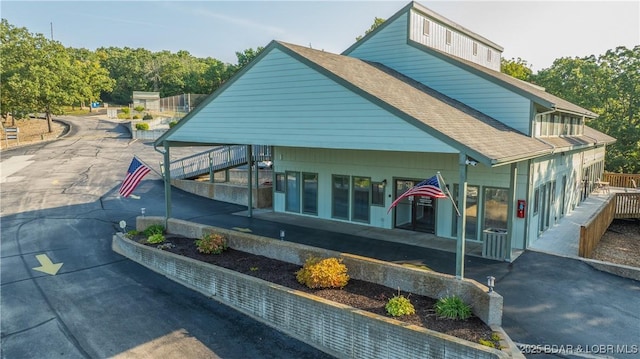 150 Southwood Shores Dr Unit 71-1B, Lake Ozark, MO 65049 - exterior space with a shingled roof and a patio area