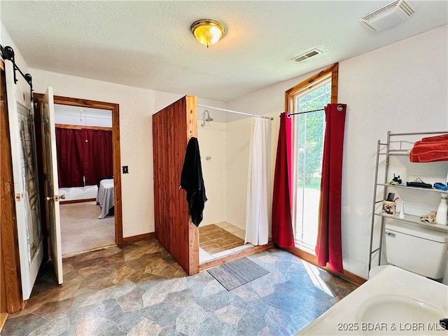 25372 Loon Blvd, Warsaw, MO 65355 - full bath featuring stone finish flooring, a stall shower, and a textured ceiling