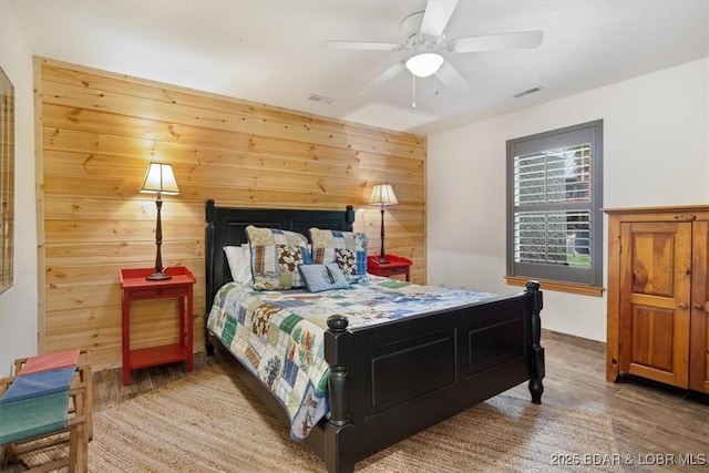 30594 Johnson Bay Rd, Gravois Mills, MO 65037 - bedroom featuring wood finished floors, wood walls, and a ceiling fan