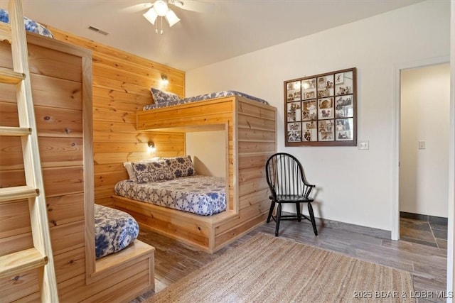 30594 Johnson Bay Rd, Gravois Mills, MO 65037 - bedroom featuring wood finished floors, wood walls, and ceiling fan