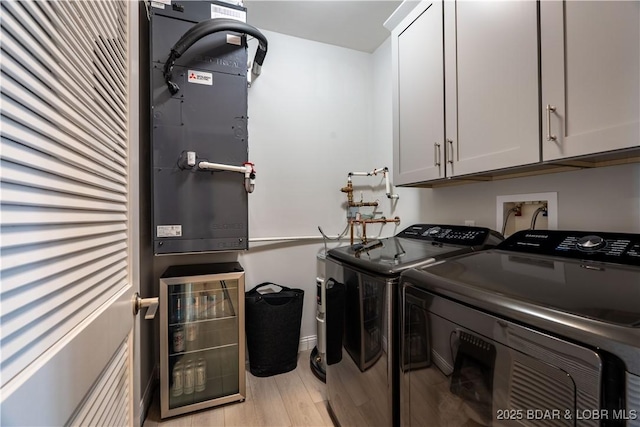 166 Captiva Dr Unit 5D, Sunrise Beach, MO 65079 - laundry area with cabinet space, independent washer and dryer, light wood-style flooring, and beverage cooler