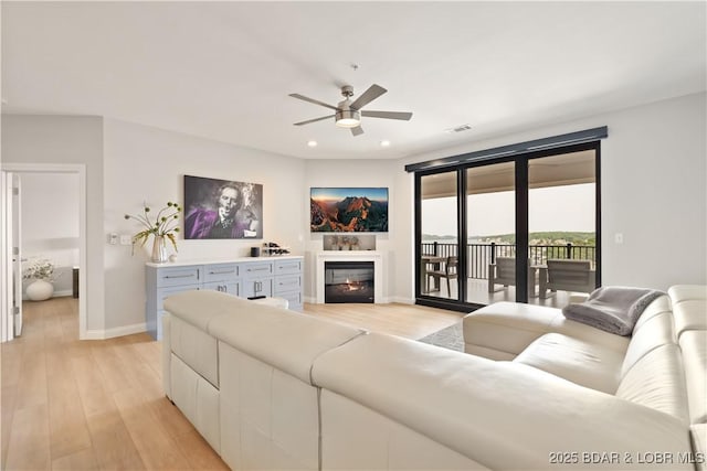 166 Captiva Dr Unit 5D, Sunrise Beach, MO 65079 - living room with ceiling fan, light wood-style floors, recessed lighting, and a glass covered fireplace