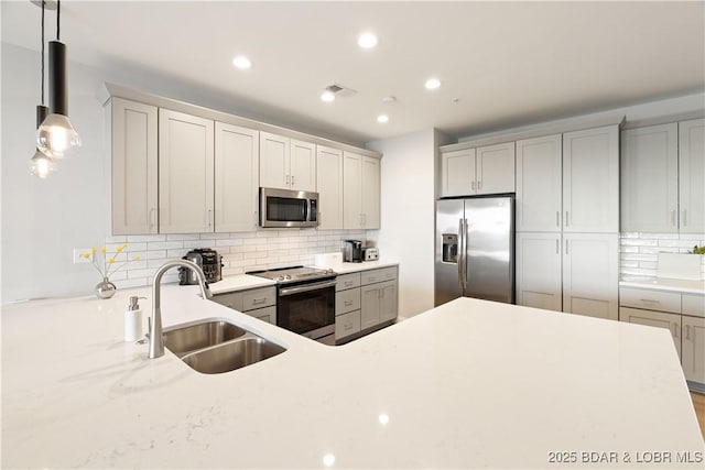 166 Captiva Dr Unit 5D, Sunrise Beach, MO 65079 - kitchen featuring appliances with stainless steel finishes, backsplash, recessed lighting, decorative light fixtures, and gray cabinets