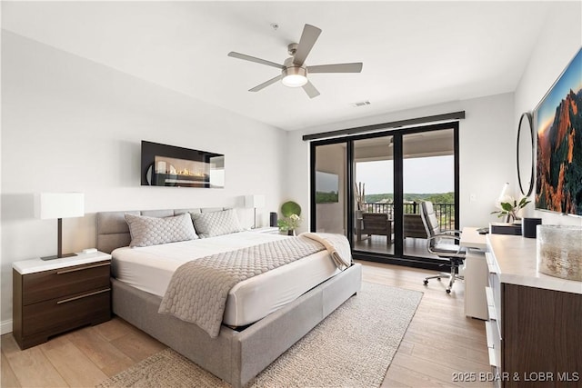 166 Captiva Dr Unit 5D, Sunrise Beach, MO 65079 - bedroom with access to exterior, light wood-style flooring, an office area, and ceiling fan