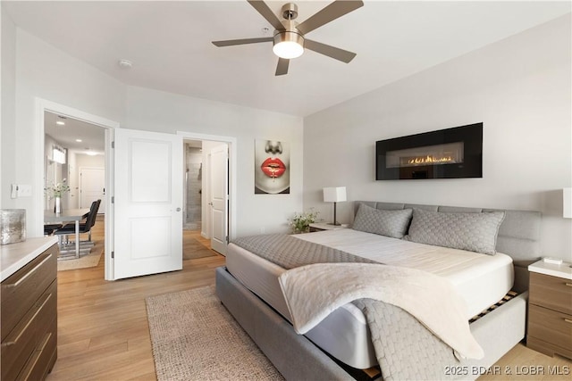 166 Captiva Dr Unit 5D, Sunrise Beach, MO 65079 - bedroom featuring light wood-style flooring and a ceiling fan