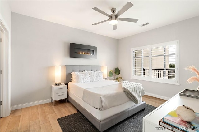 166 Captiva Dr Unit 5D, Sunrise Beach, MO 65079 - bedroom with light wood-style flooring and a ceiling fan