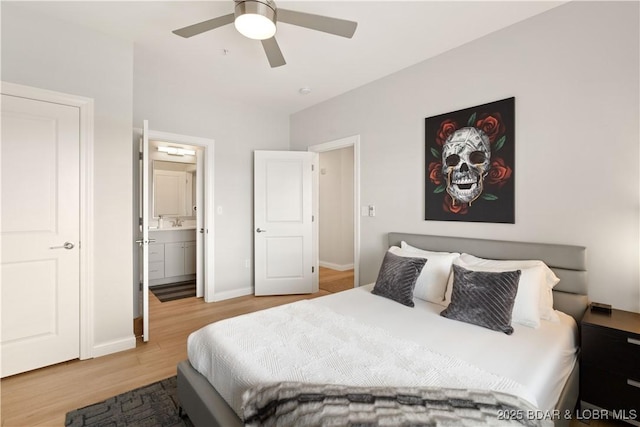 166 Captiva Dr Unit 5D, Sunrise Beach, MO 65079 - bedroom with wood finished floors, ensuite bathroom, and a ceiling fan