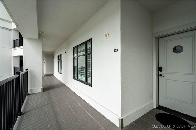 166 Captiva Dr Unit 5D, Sunrise Beach, MO 65079 - doorway to property with a balcony and stucco siding