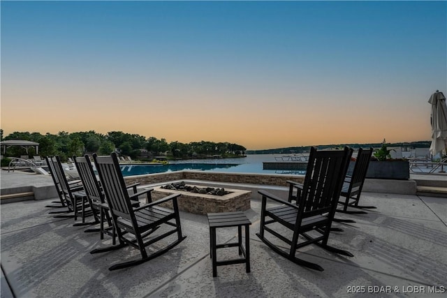 166 Captiva Dr Unit 5D, Sunrise Beach, MO 65079 - view of patio featuring an outdoor fire pit, a water view, and an outdoor pool