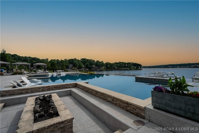 166 Captiva Dr Unit 5D, Sunrise Beach, MO 65079 - view of swimming pool featuring a gazebo, a water view, an infinity pool, a jacuzzi, and a patio area