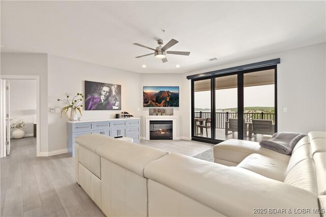 166 Captiva Dr Unit 5D, Sunrise Beach, MO 65079 - living area with ceiling fan, light wood-style flooring, a glass covered fireplace, and recessed lighting