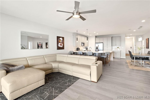 166 Captiva Dr Unit 5D, Sunrise Beach, MO 65079 - living area with light wood-style floors, a ceiling fan, and recessed lighting
