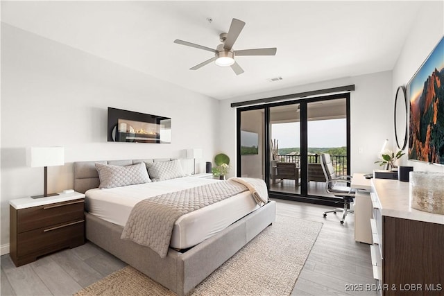 166 Captiva Dr Unit 5D, Sunrise Beach, MO 65079 - bedroom featuring access to outside, light wood finished floors, ceiling fan, and an office area