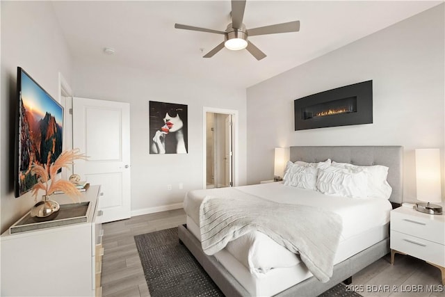 166 Captiva Dr Unit 5D, Sunrise Beach, MO 65079 - bedroom featuring wood finished floors and a ceiling fan