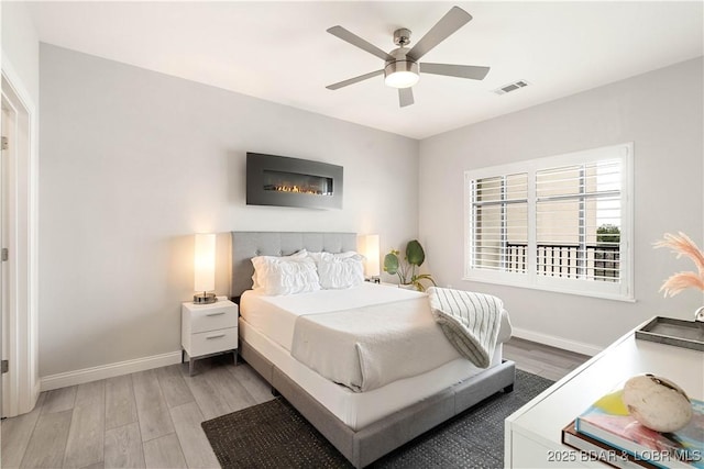 166 Captiva Dr Unit 5D, Sunrise Beach, MO 65079 - bedroom featuring light wood-style flooring and ceiling fan