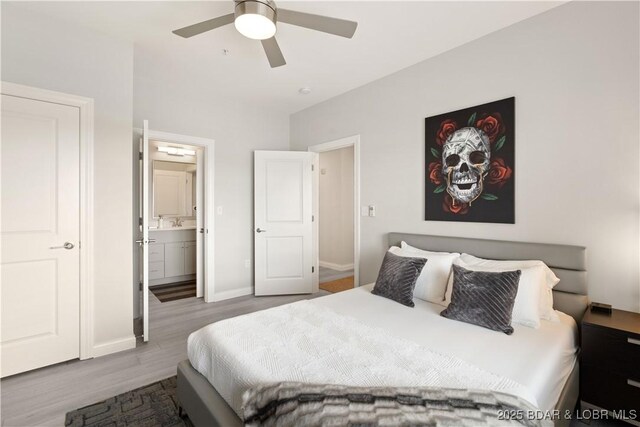 166 Captiva Dr Unit 5D, Sunrise Beach, MO 65079 - bedroom with wood finished floors, ensuite bathroom, and a ceiling fan