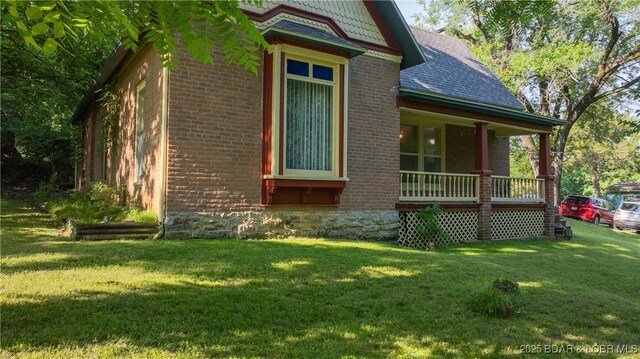 87 Outback Loop, Linn Creek, MO 65052 - view of property exterior featuring brick siding, covered porch, and a lawn