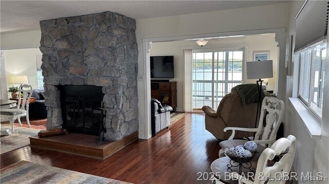 28136 Lyndsey Ln, Rocky Mount, MO 65072 - living area with a fireplace, plenty of natural light, and hardwood / wood-style floors