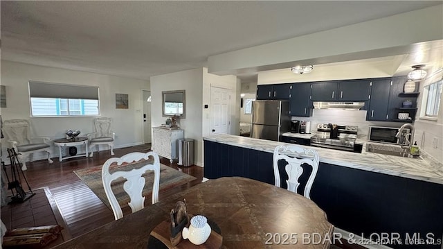 28136 Lyndsey Ln, Rocky Mount, MO 65072 - kitchen featuring appliances with stainless steel finishes, under cabinet range hood, light countertops, and a peninsula
