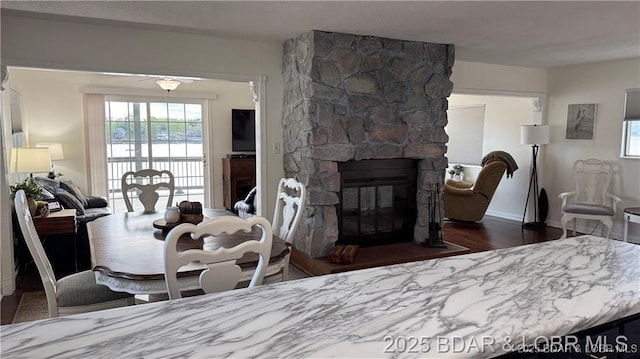 28136 Lyndsey Ln, Rocky Mount, MO 65072 - dining area with wood finished floors, healthy amount of natural light, and a fireplace