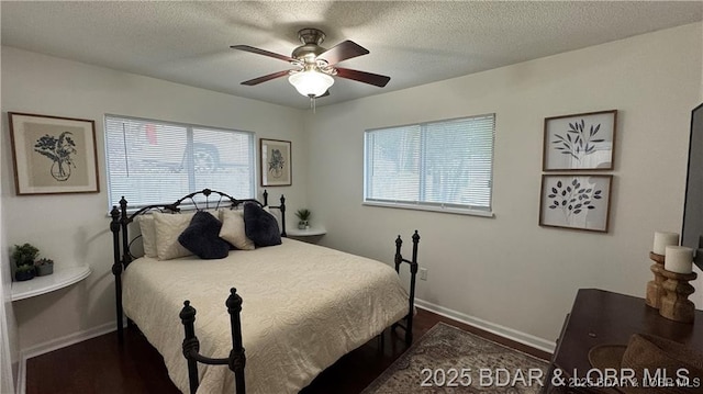 28136 Lyndsey Ln, Rocky Mount, MO 65072 - bedroom featuring multiple windows, a textured ceiling, ceiling fan, and dark wood-style floors